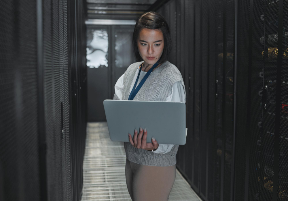 woman-with-laptop-server-room-it-engineer-datacenter-with-software-update-programming-tech-industry-cybersecurity-network-with-asian-female-setting-up-firewall-database.jpg